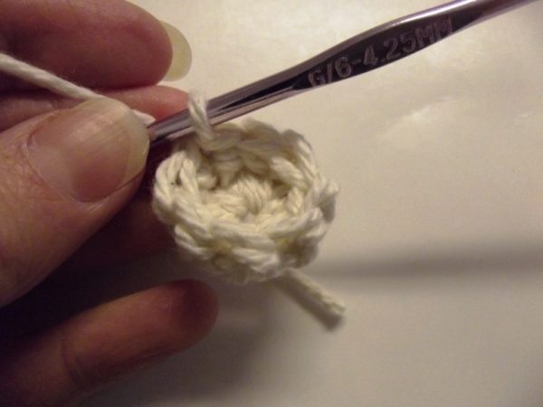 The second round is worked with one single crochet in each stitch. This causes the edge to curl, which is what you want.