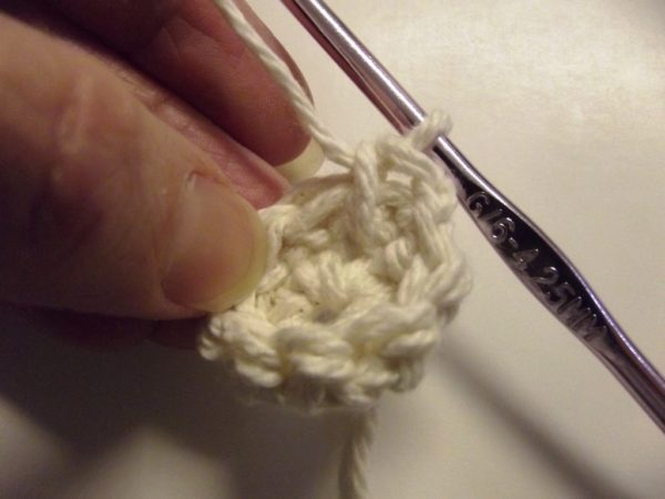 Wrap the yarn over again to complete the single crochet stitch.