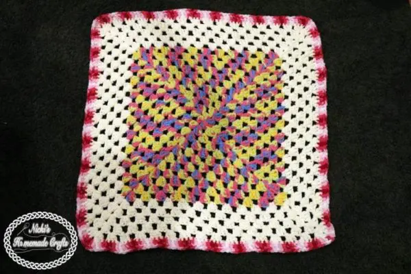 Crochet granny square blanket shown in a color block striped design.