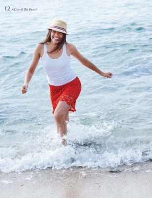 Woman in a lake wearing a red crocheted skirt.