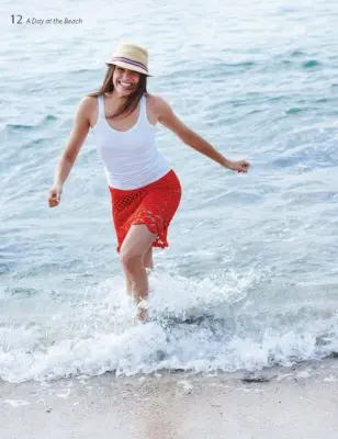 Woman in a lake wearing a red crocheted skirt.