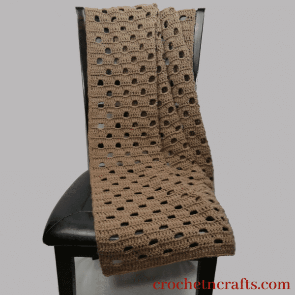 Crochet lapghan draped over a chair.