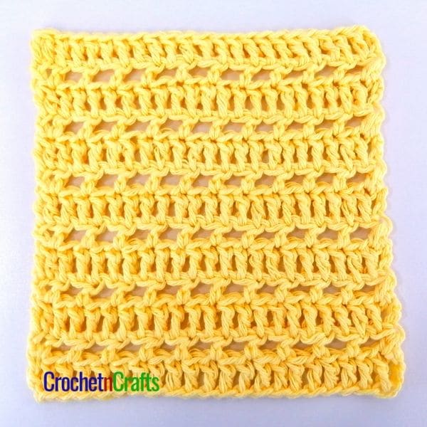An open stitch dishcloth laid flat.
