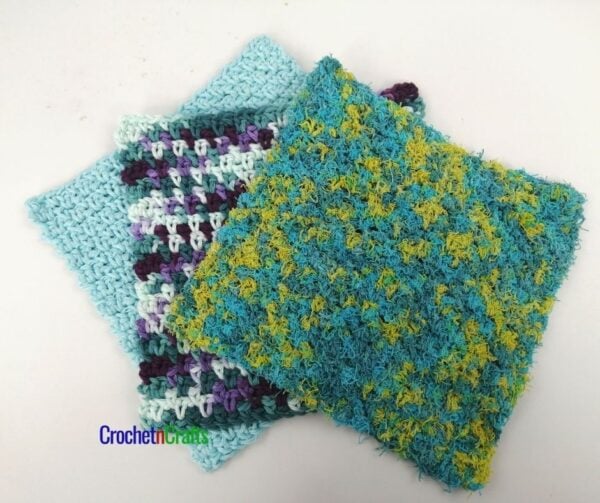Crochet dishcloth shown in three types of yarn, a solid, a variegated and a scrubby cotton.