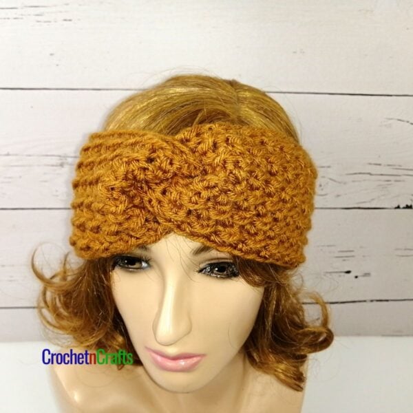 Crochet ear warmer shown on a mannequin.