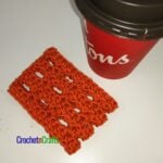 Simple and lacy crochet cup cozy laid flat.