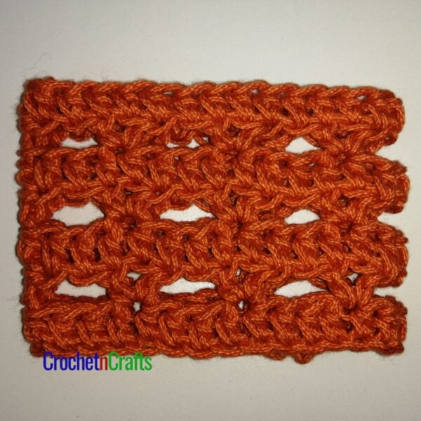Simple and lacy crochet cup cozy laid flat.
