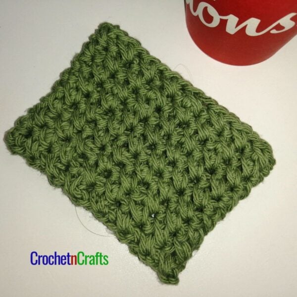 Crochet cup cozy laid flat.