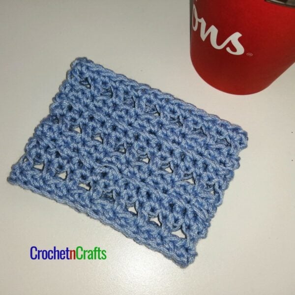 Crochet cup cozy laid flat.