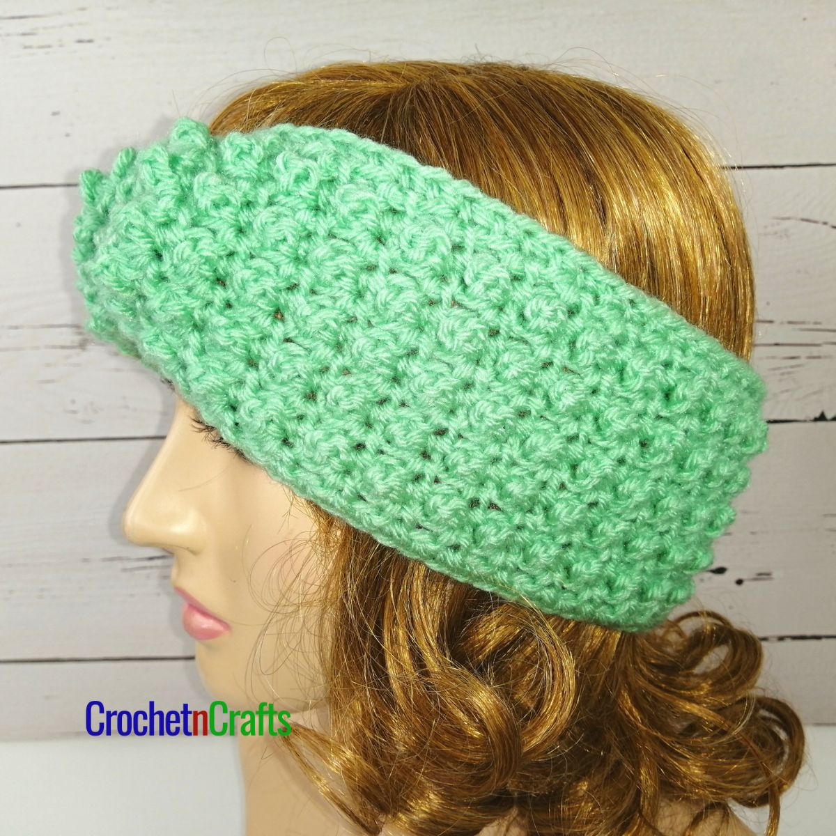 A twist crochet ear warmer is shown on a mannequin.