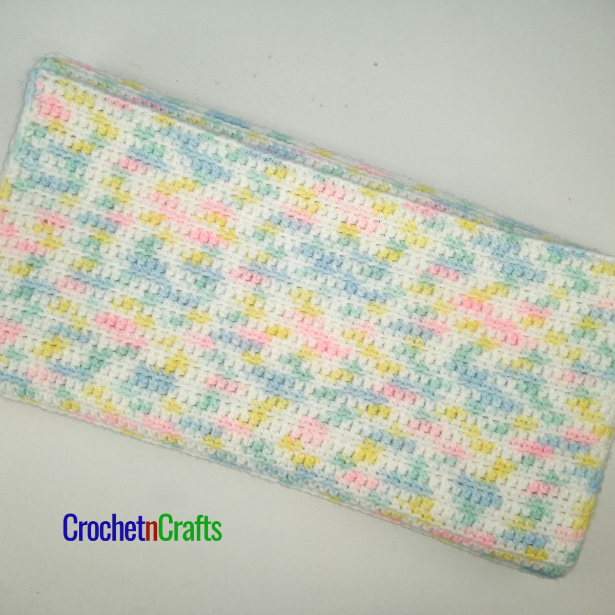 Single crochet baby blanket folded up.