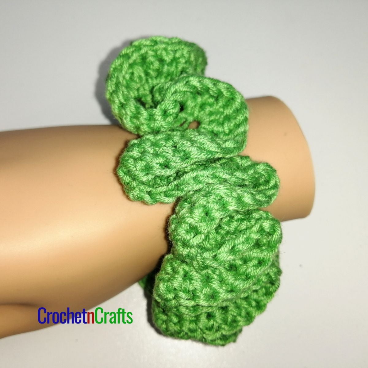 Crochet hair scrunchie shown in green yarn.