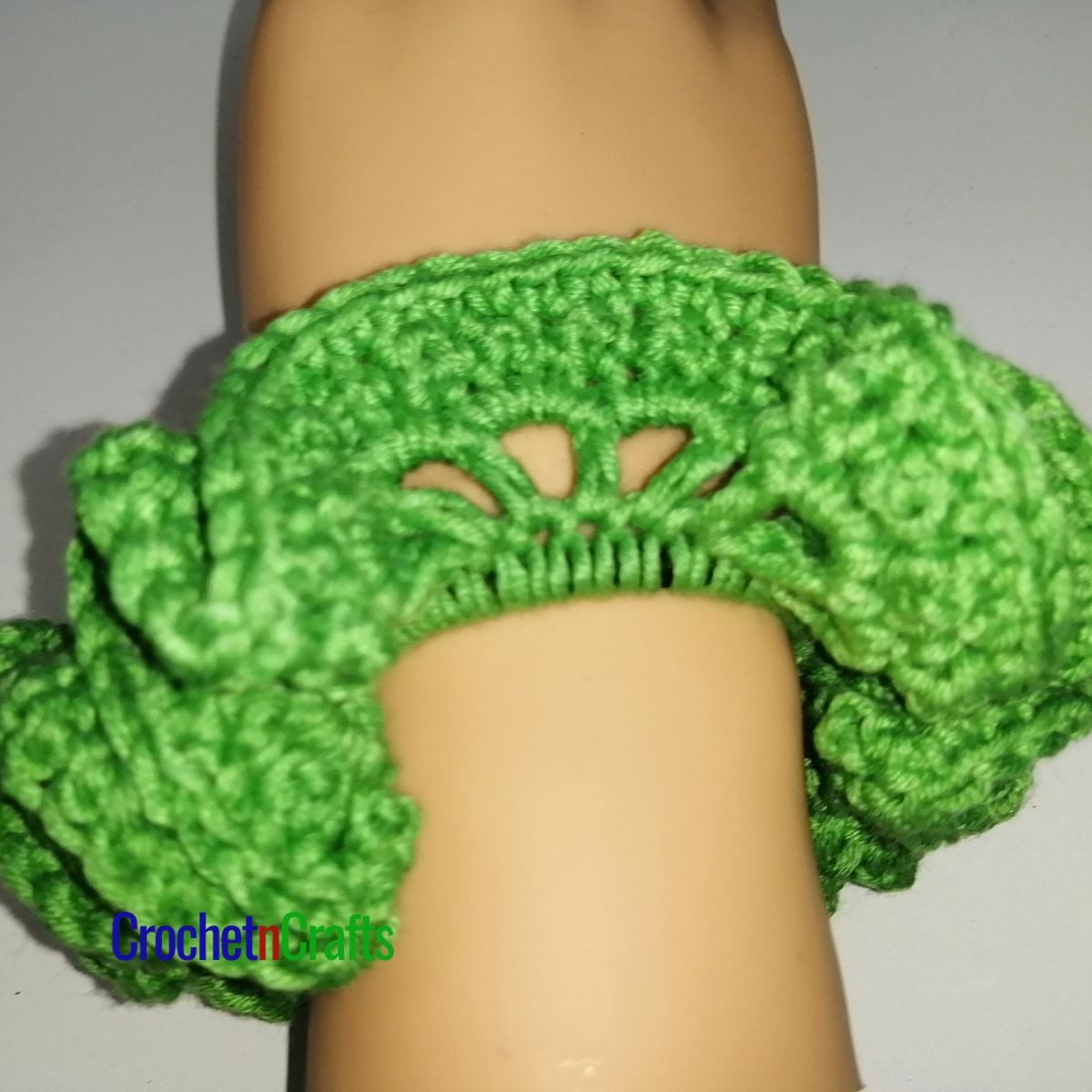 Crochet hair scrunchie shown in green yarn.