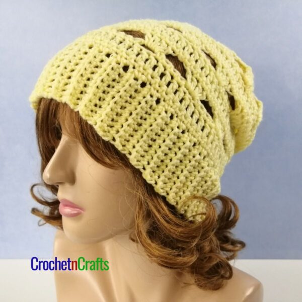 Crochet lacy hat shown on a mannequin