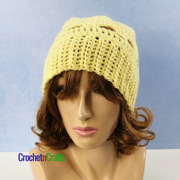 Crochet lacy hat shown on a mannequin