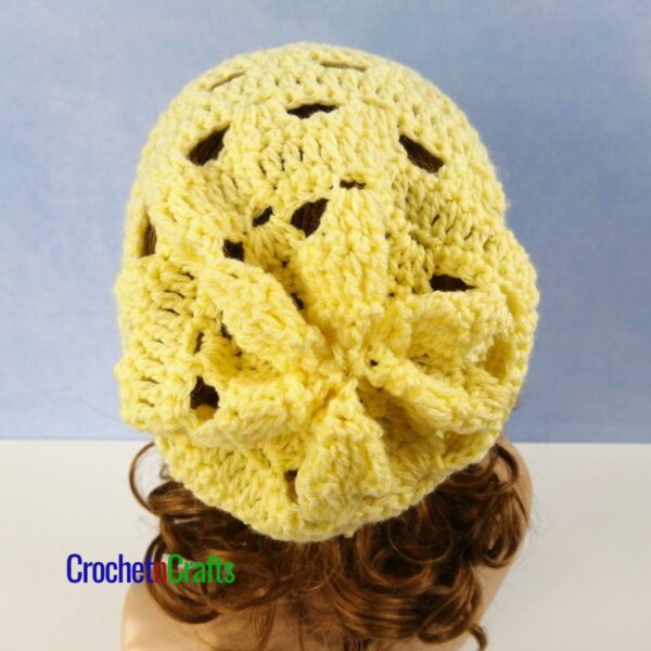 Crochet lacy hat shown on a mannequin - back view