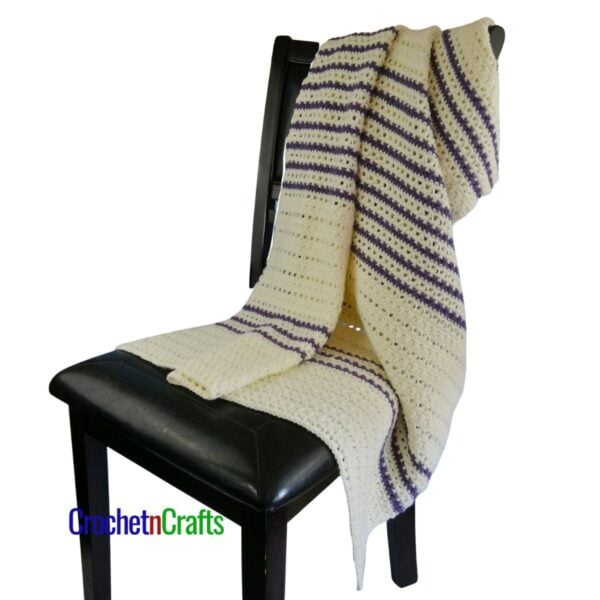 Crochet blanket draped over a chair.