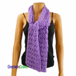 Crocheted scarf shown on a mannequin. Tied in a knot at the front.