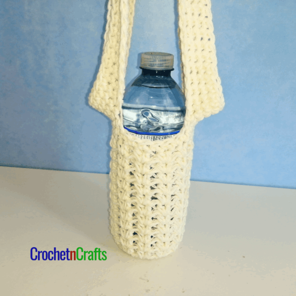Crochet water bottle holder with a 500ml water bottle.