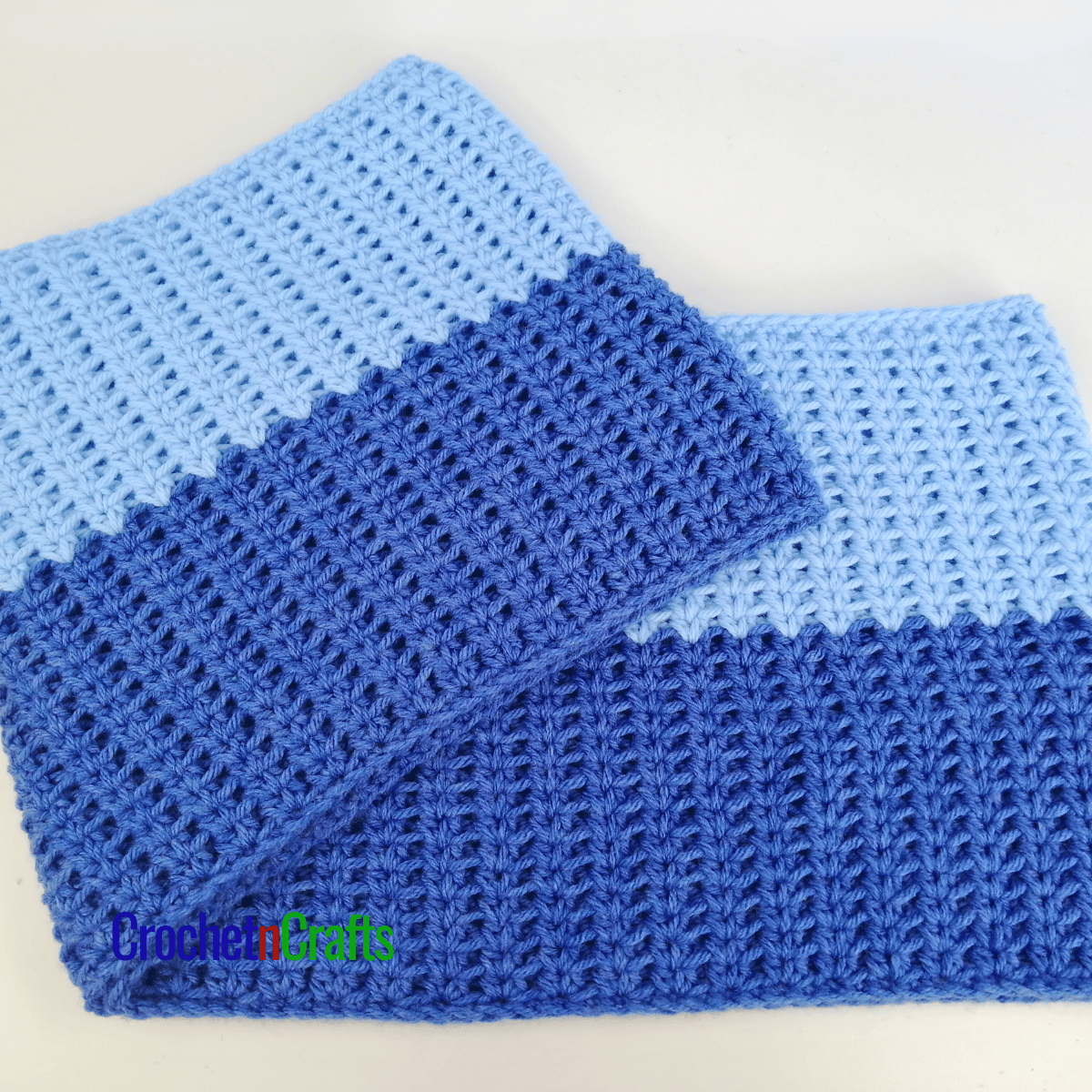 A crochet cowl laid flat.