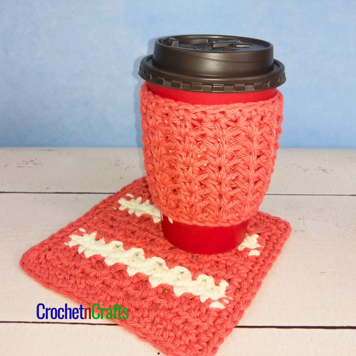 Crochet cup cozy shown on a take-out cup along wit a coaster to match.