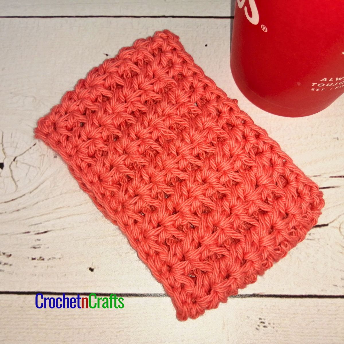 Crochet cup cozy laid flat.