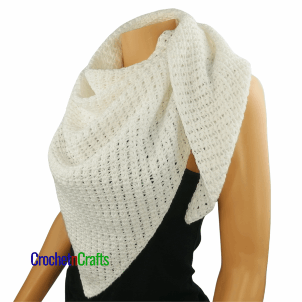 Crochet shawl shown on a mannequin - side view.