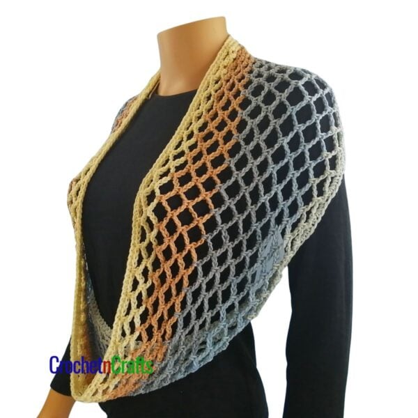 Crochet diamond mesh cowl draped over the shoulders.