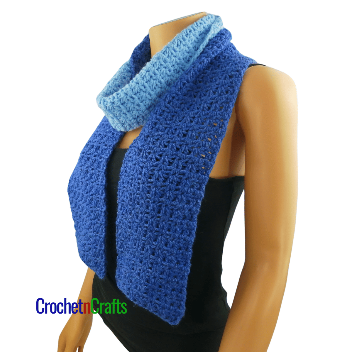A crocheted scarf worn on the mannequin - wrapped around the neck once.