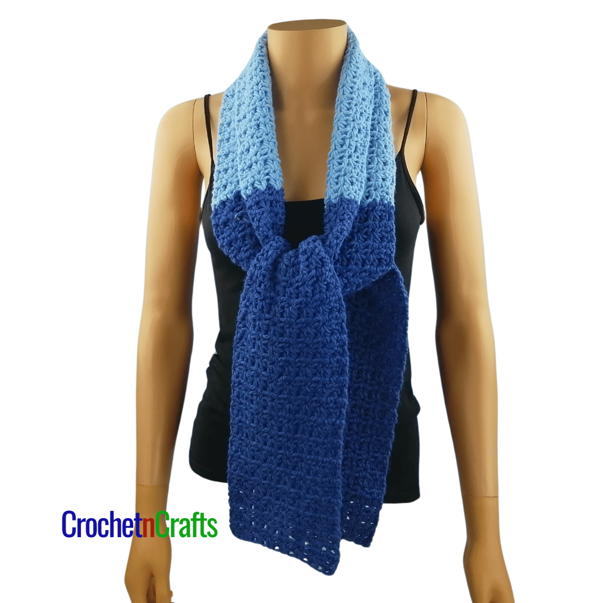 A crocheted scarf worn on the mannequin - tied at the front.