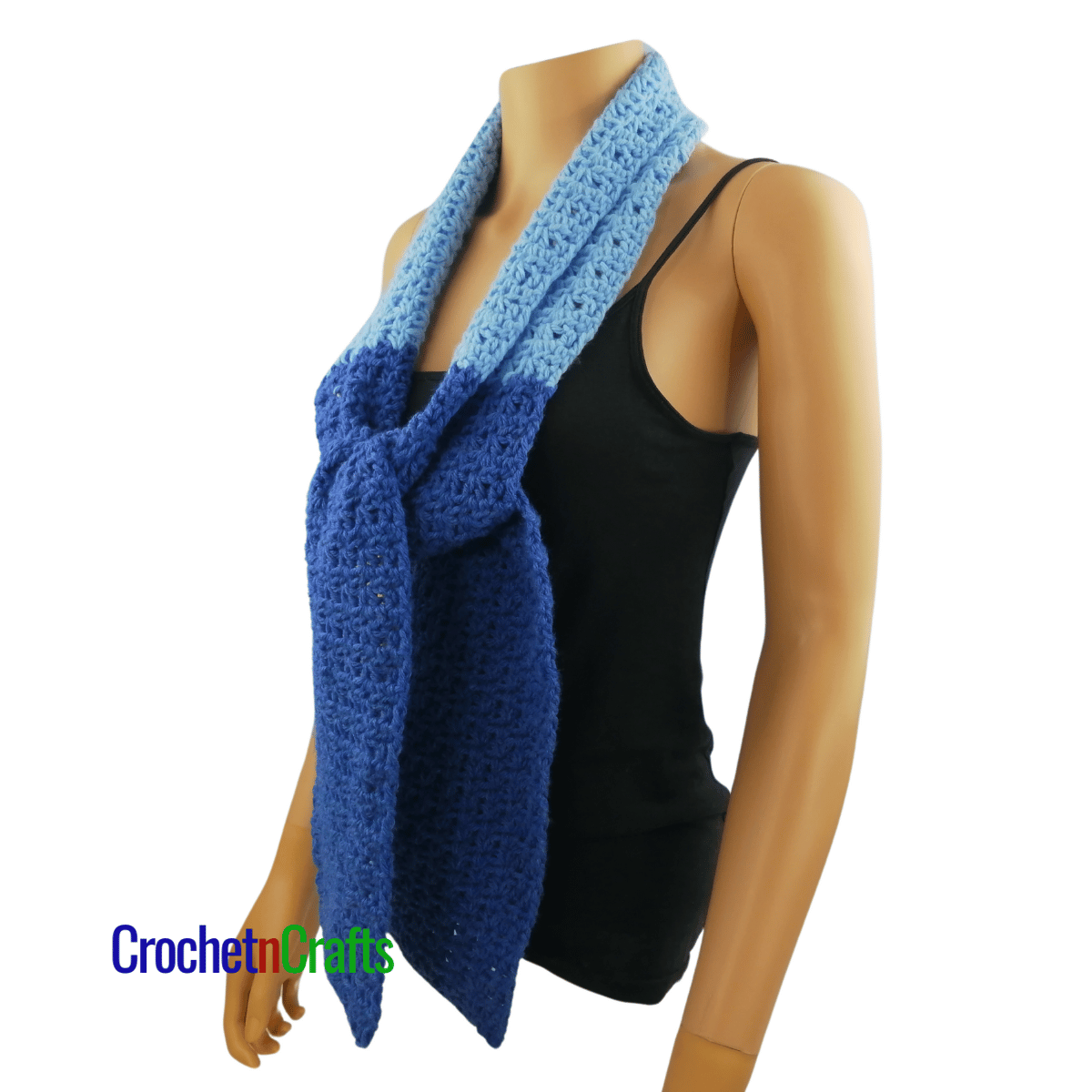 A crocheted scarf worn on the mannequin - tied at the front - side view.