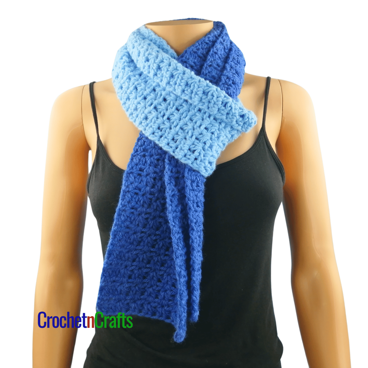 A crocheted scarf worn on the mannequin - looped through at the front.