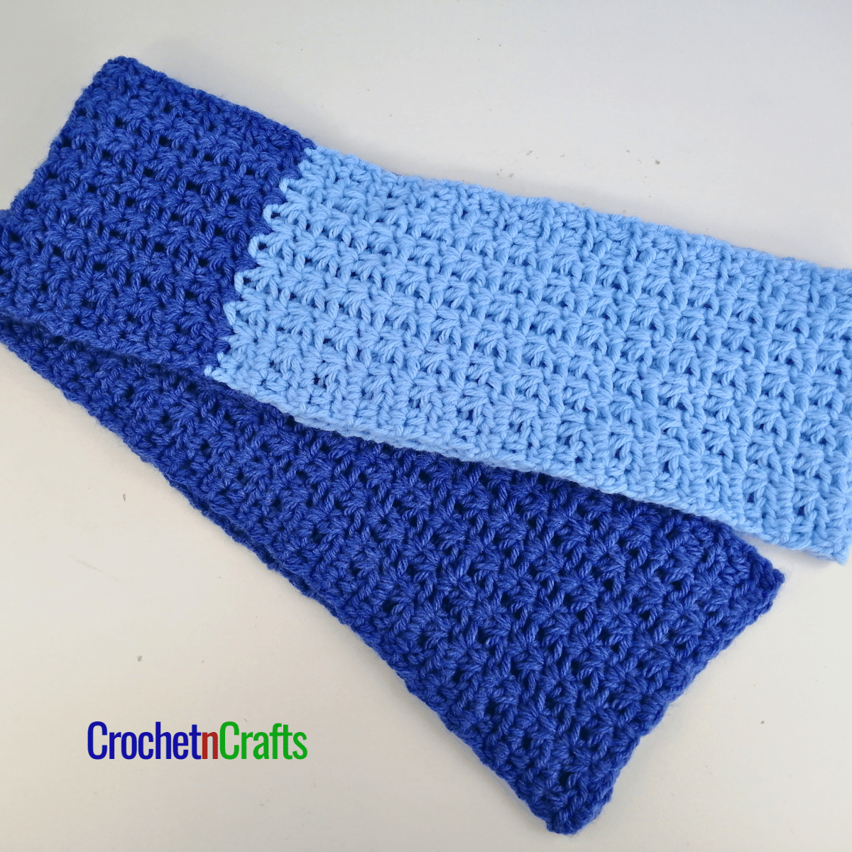A colorblock crochet scarf folded.