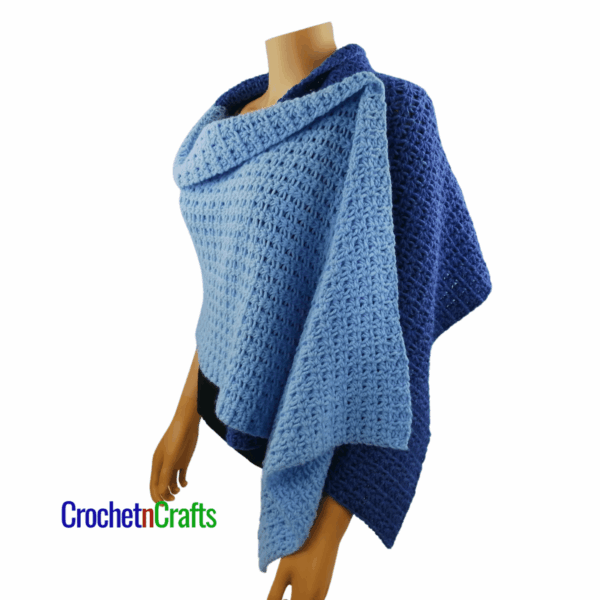 A crocheted shawl worn on a mannequin - side view