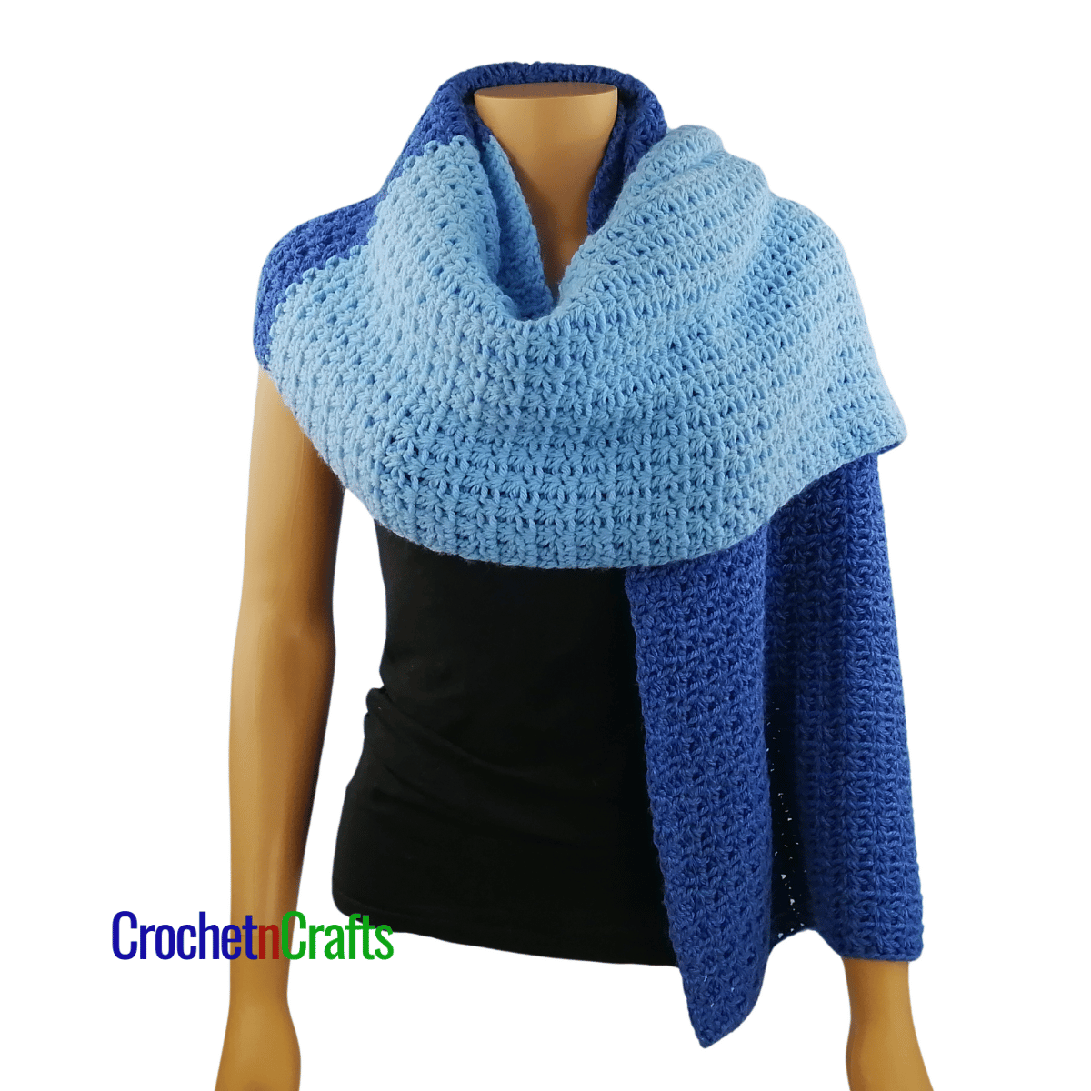 A crocheted shawl worn on a mannequin - worn like a scarf.