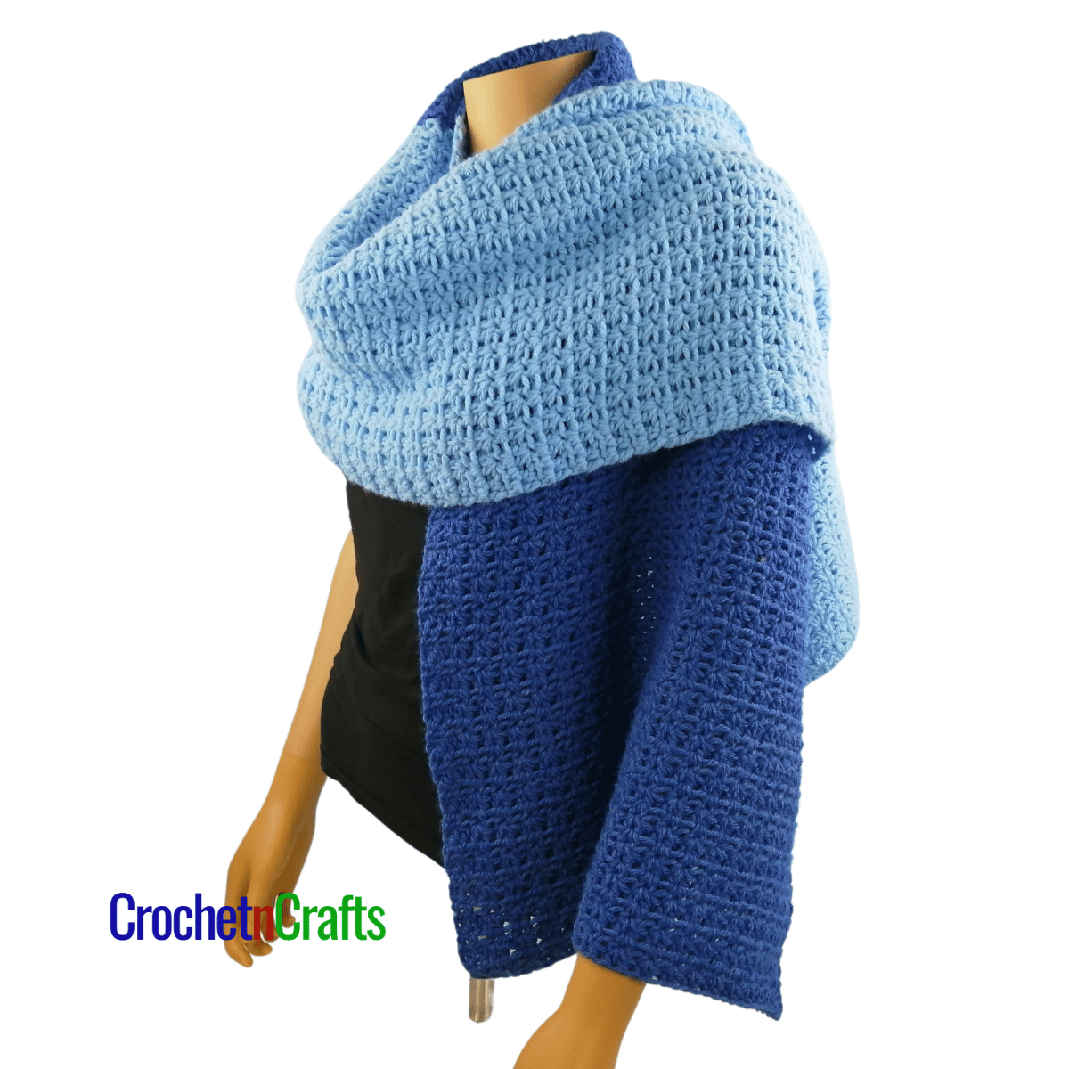 A crocheted shawl worn on a mannequin - worn like a scarf - side view.