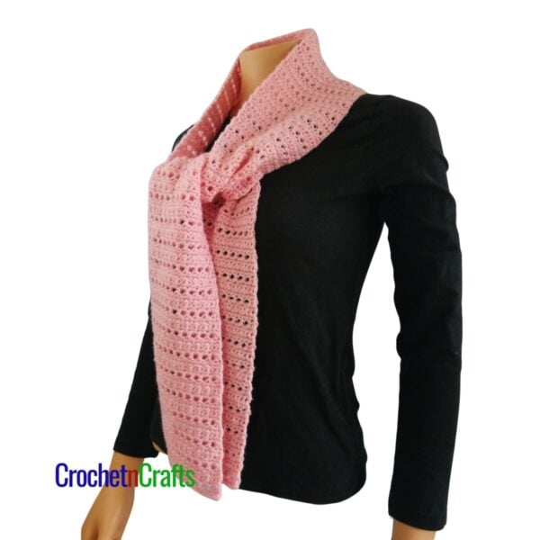 A crocheted scarf tied at the front - side view.