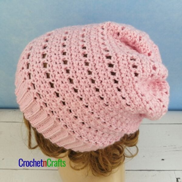A crocheted lightweight hat pattern modeled on a mannequin.
