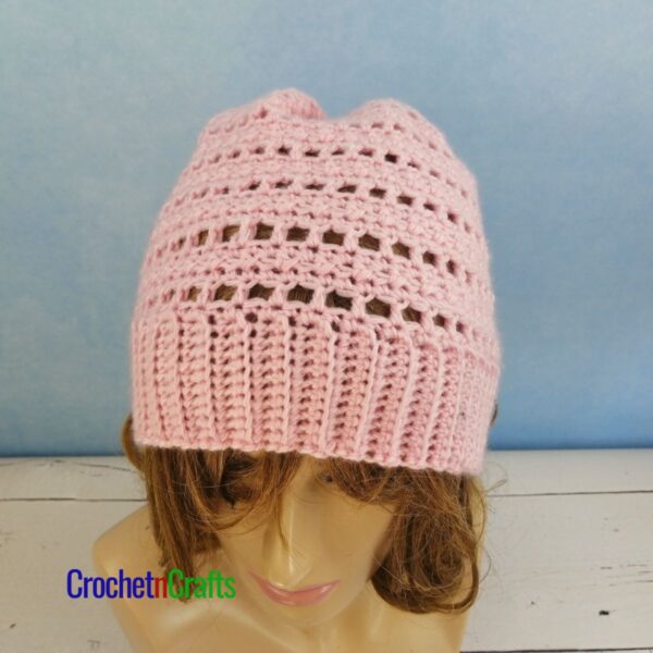 A crocheted lightweight hat pattern modeled on a mannequin.