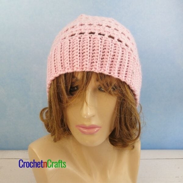 A crocheted lightweight hat pattern modeled on a mannequin.
