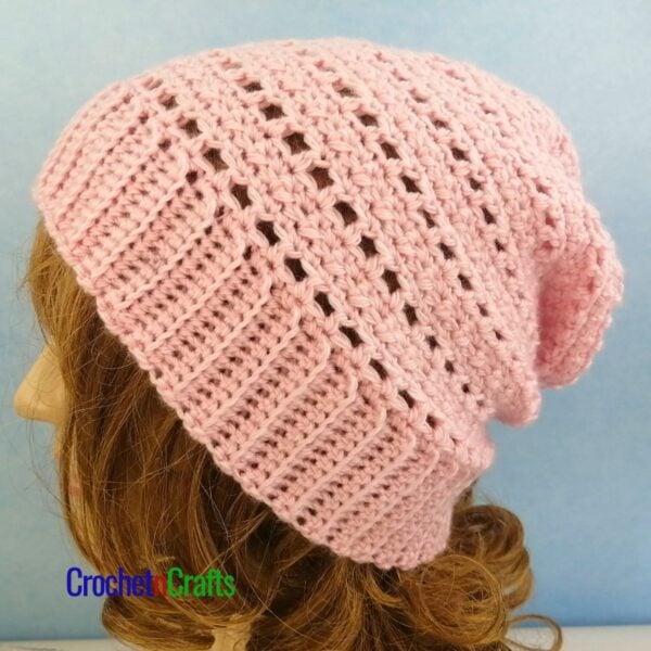 A crocheted lightweight hat pattern modeled on a mannequin.