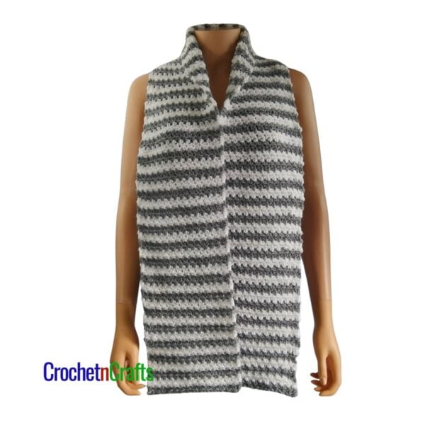 A striped crochet scarf worn on a mannequin.