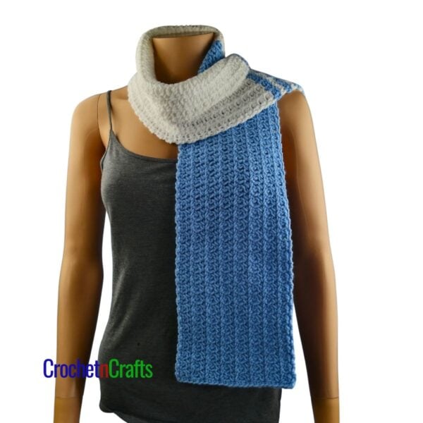 A crochet spider stitch scarf worn around the neck.