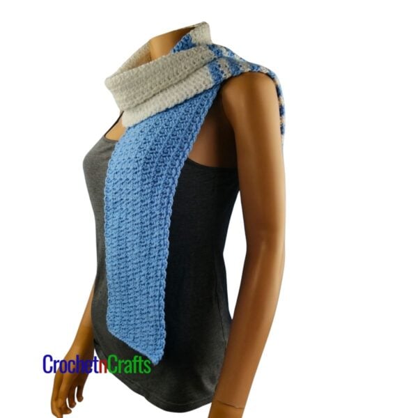 A crochet spider stitch scarf worn around the neck - side view.