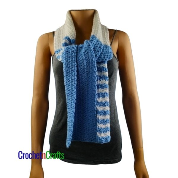 A crochet spider stitch scarf tied at the front.