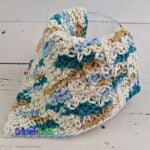 A crocheted dishcloth draped over a glass.
