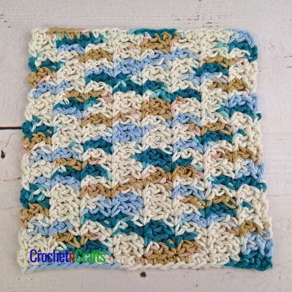A crocheted dishcloth laying flat.