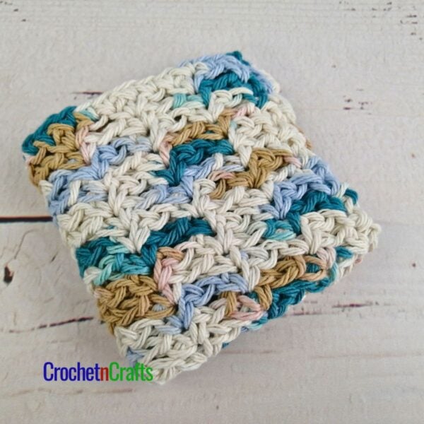 A crocheted dishcloth folded up.