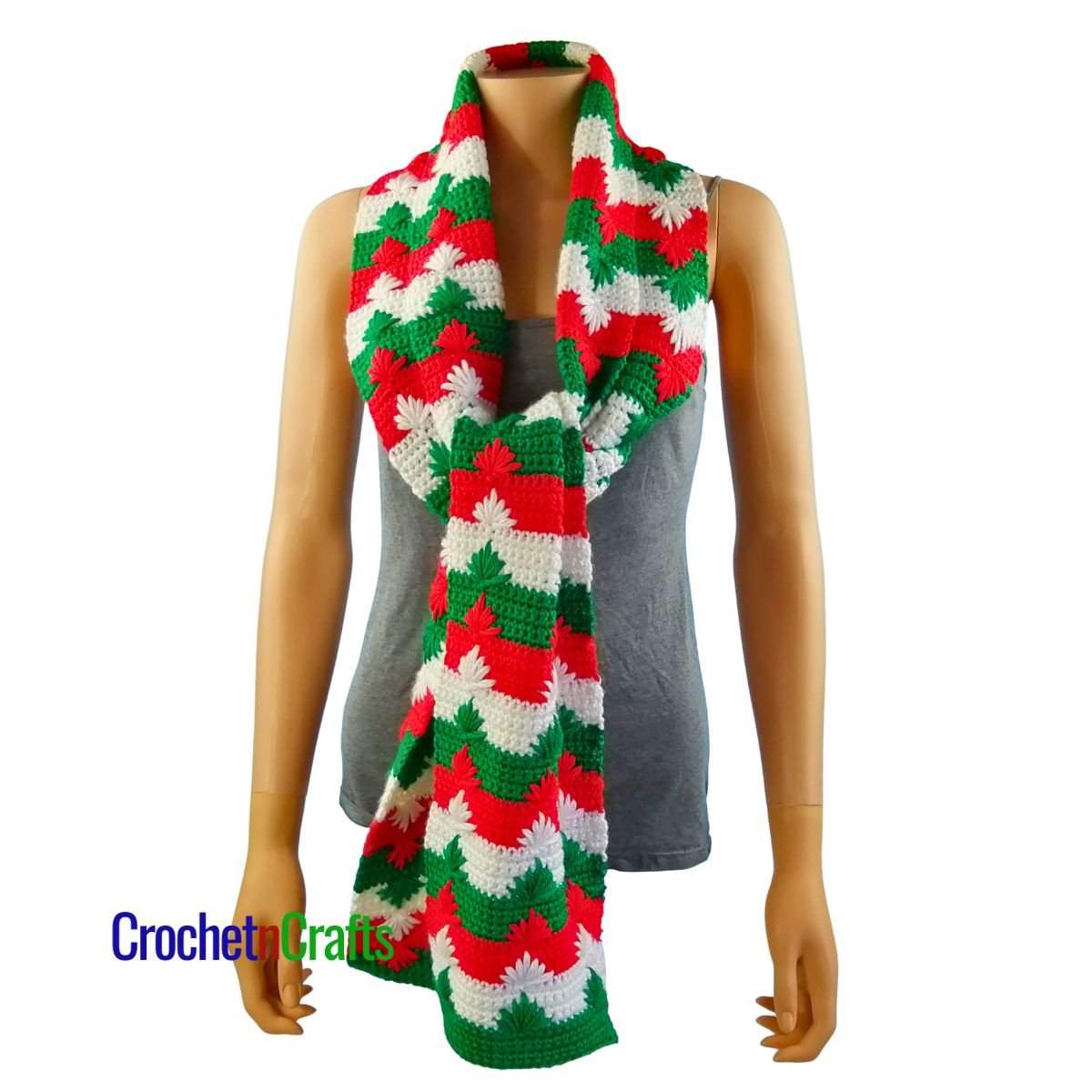 A Christmas crochet scarf tied in a knot at the front.