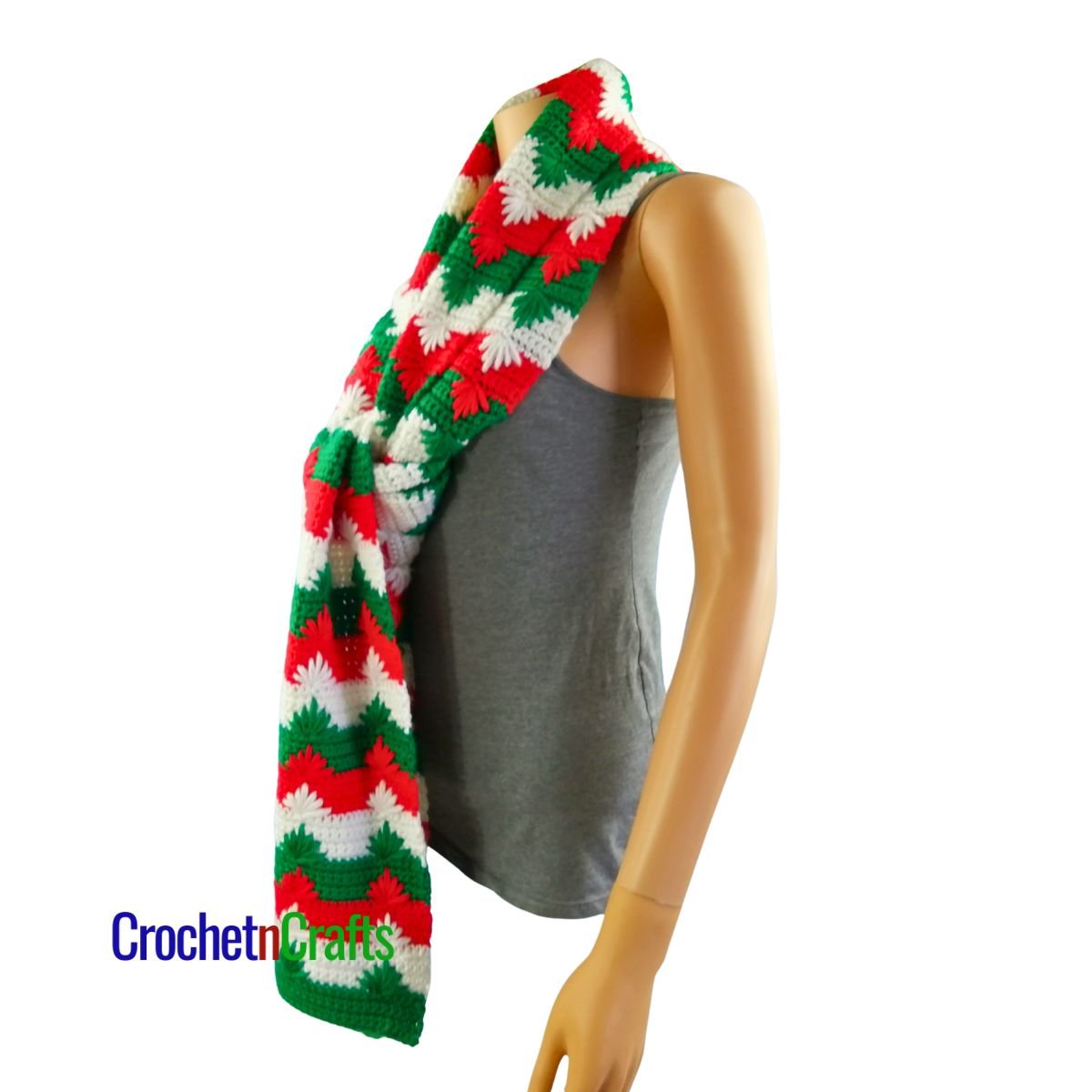 A Christmas crochet scarf tied in a knot at the front - side view.
